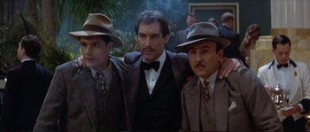 Movie still from “The Rocketeer” (1991), directed by Joe Johnston – A group of men standing next to each other wearing hats; Medium shot, High angle