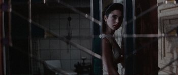 Movie still from “The Rocketeer” (1991), directed by Joe Johnston – A woman standing in front of a window; Close Up shot, Over the shoulder angle