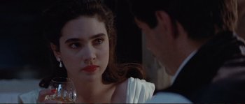 Movie still from “The Rocketeer” (1991), directed by Joe Johnston – A woman with red lipstick sitting next to a man; Close Up shot, Over the shoulder angle