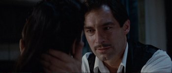 Movie still from “The Rocketeer” (1991), directed by Joe Johnston – A person sitting with a man; Close Up shot, Over the shoulder angle