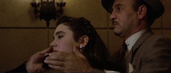 Movie still from “The Rocketeer” (1991), directed by Joe Johnston – A woman getting her hair cut by a barber; Close Up shot, Over the shoulder angle