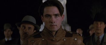 Movie still from “The Rocketeer” (1991), directed by Joe Johnston – A person wearing a leather jacket; Close Up shot, Over the shoulder angle