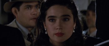 Movie still from “The Rocketeer” (1991), directed by Joe Johnston – A person wearing a dress; Close Up shot, Over the shoulder angle