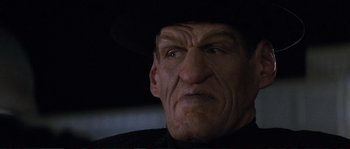 Movie still from “The Rocketeer” (1991), directed by Joe Johnston – An old man wearing a black cowboy hat; Close Up shot, Low angle