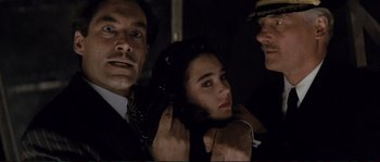 Movie still from “The Rocketeer” (1991), directed by Joe Johnston – A man and a woman in a dark room; Close Up shot, Over the shoulder angle