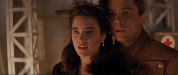 Movie still from “The Rocketeer” (1991), directed by Joe Johnston – A man and a woman standing next to each other; Close Up shot, Low angle