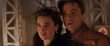 Movie still from “The Rocketeer” (1991), directed by Joe Johnston – A man and a woman standing next to each other; Close Up shot, Low angle