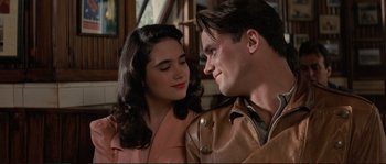 Movie still from “The Rocketeer” (1991), directed by Joe Johnston – A man and a woman are looking at one another; Close Up shot, Low angle
