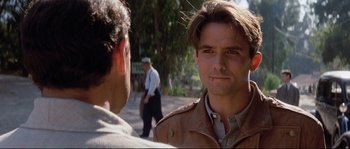Movie still from “The Rocketeer” (1991), directed by Joe Johnston – A man in a brown jacket talking to another man in a brown jacket; Close Up shot, Over the shoulder angle