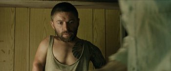 Movie still from “The Rover” (2014), directed by David Michôd – A man with a beard looking into a mirror; Close Up shot, Over the shoulder angle