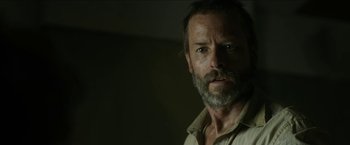 Movie still from “The Rover” (2014), directed by David Michôd – A person with a beard; Close Up shot, Low angle