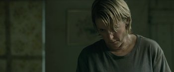Movie still from “The Rover” (2014), directed by David Michôd – A woman with blonde hair is looking at the camera; Close Up shot, Over the shoulder angle
