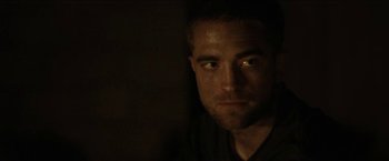 Movie still from “The Rover” (2014), directed by David Michôd – A person looking at the camera; Close Up shot, Over the shoulder angle