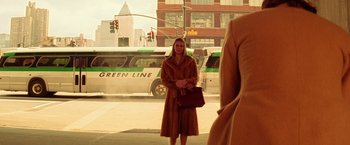 Movie still from “The Royal Tenenbaums” (2001), directed by Wes Anderson – A woman standing on the side of the road in front of a green line bus; Medium shot, Over the shoulder angle