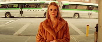 Movie still from “The Royal Tenenbaums” (2001), directed by Wes Anderson – A woman in a brown coat standing in front of a white van; Close Up shot, Low angle