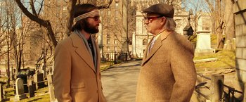 Movie still from “The Royal Tenenbaums” (2001), directed by Wes Anderson – Two men are standing on the sidewalk talking; Medium shot, Over the shoulder angle