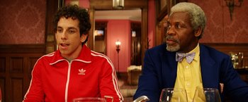 Movie still from “The Royal Tenenbaums” (2001), directed by Wes Anderson – Two men sitting at a table in front of each other; Close Up shot, Over the shoulder angle