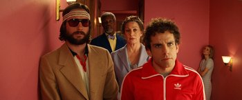Movie still from “The Royal Tenenbaums” (2001), directed by Wes Anderson – A group of people standing next to each other in a room; Medium shot, Low angle