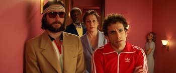 Movie still from “The Royal Tenenbaums” (2001), directed by Wes Anderson – A group of people standing next to each other in a room; Medium shot, Low angle