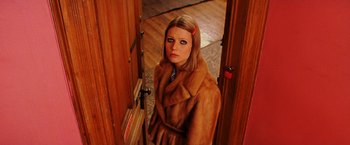 Movie still from “The Royal Tenenbaums” (2001), directed by Wes Anderson – A woman in a fur coat standing in a door way; Close Up shot, High angle