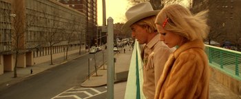 Movie still from “The Royal Tenenbaums” (2001), directed by Wes Anderson – A man and a woman standing next to each other on a sidewalk; Medium shot, Low angle