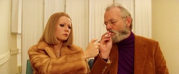 Movie still from “The Royal Tenenbaums” (2001), directed by Wes Anderson – An older man and a young woman are smoking; Close Up shot, Low angle