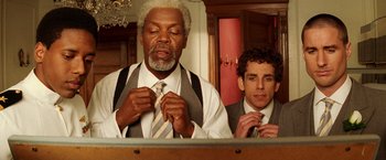 Movie still from “The Royal Tenenbaums” (2001), directed by Wes Anderson – Two men in suits and ties are looking at each other; Close Up shot, Low angle