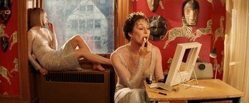 Movie still from “The Royal Tenenbaums” (2001), directed by Wes Anderson – A woman sitting in front of a computer; Medium shot, High angle