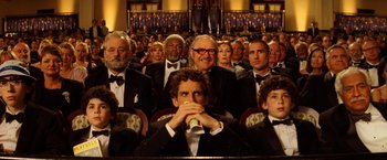Movie still from “The Royal Tenenbaums” (2001), directed by Wes Anderson – A group of people sitting in a room; Medium shot, Over the shoulder angle