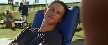 Movie still from “The Ruins” (2008), directed by Carter Smith – A man sitting in a chair with his head resting on a pillow; Close Up shot, High angle