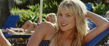 Movie still from “The Ruins” (2008), directed by Carter Smith – A beautiful blonde woman sitting on a bench; Close Up shot, Over the shoulder angle