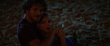 Movie still from “The Ruins” (2008), directed by Carter Smith – A man and a woman sitting next to each other; Close Up shot, High angle