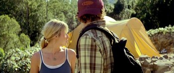 Movie still from “The Ruins” (2008), directed by Carter Smith – A man and a woman standing next to each other; Medium shot, Over the shoulder angle