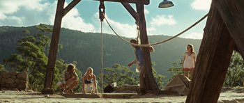 Movie still from “The Ruins” (2008), directed by Carter Smith – A man is hanging from a rope by a rope; Wide shot, Low angle