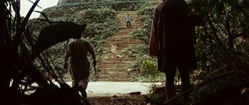 Movie still from “The Ruins” (2008), directed by Carter Smith – A group of people walking up a set of stairs; Extreme Wide shot, High angle