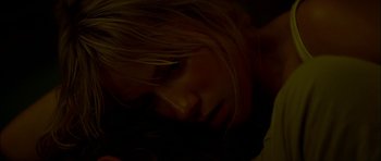 Movie still from “The Ruins” (2008), directed by Carter Smith – A woman's face in the dark; Extreme Close Up shot, Overhead angle