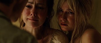 Movie still from “The Ruins” (2008), directed by Carter Smith – Two women standing next to each other in a room; Close Up shot, High angle
