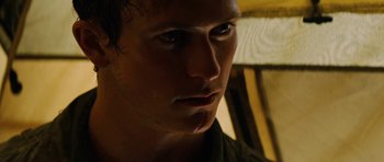 Movie still from “The Ruins” (2008), directed by Carter Smith – A man's face in the dark; Close Up shot, Low angle