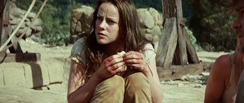 Movie still from “The Ruins” (2008), directed by Carter Smith – A woman sitting on the ground with her hands in front of her face; Close Up shot, Low angle