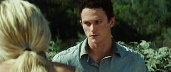 Movie still from “The Ruins” (2008), directed by Carter Smith – A person wearing a green shirt; Close Up shot, Over the shoulder angle