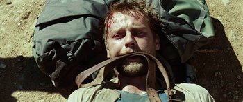 Movie still from “The Ruins” (2008), directed by Carter Smith – A person laying on the ground; Close Up shot, High angle