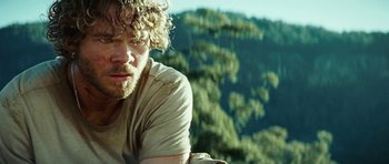 Movie still from “The Ruins” (2008), directed by Carter Smith – A person with a beard; Close Up shot, Over the shoulder angle