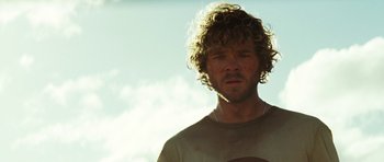 Movie still from “The Ruins” (2008), directed by Carter Smith – A person wearing a shirt; Close Up shot, Low angle