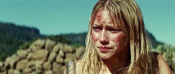 Movie still from “The Ruins” (2008), directed by Carter Smith – A young woman is crying while holding a water bottle in her hand; Close Up shot, Over the shoulder angle