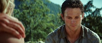 Movie still from “The Ruins” (2008), directed by Carter Smith – A person wearing a camouflage shirt; Close Up shot, Low angle