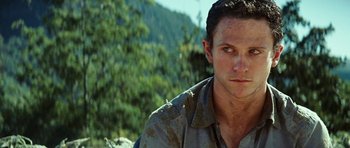 Movie still from “The Ruins” (2008), directed by Carter Smith – A person wearing a shirt; Close Up shot, Low angle