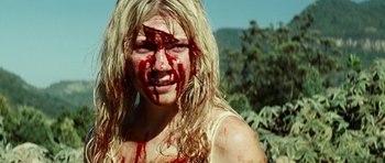 Movie still from “The Ruins” (2008), directed by Carter Smith – A woman with blood all over her face; Close Up shot, High angle
