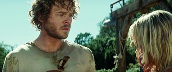Movie still from “The Ruins” (2008), directed by Carter Smith – A person wearing a shirt; Close Up shot, Over the shoulder angle