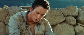 Movie still from “The Ruins” (2008), directed by Carter Smith – A man with dirt all over his face and chest; Close Up shot, High angle