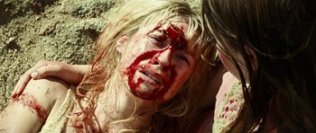 Movie still from “The Ruins” (2008), directed by Carter Smith – A woman with blood all over her face; Close Up shot, Overhead angle